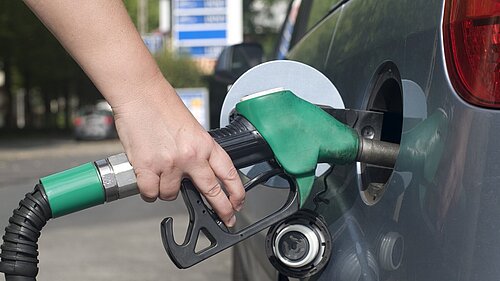 A person filling their car with petrol.