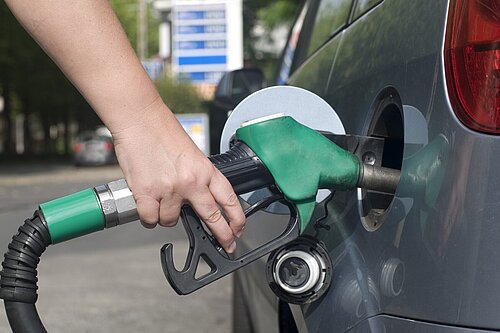 A person filling their car with petrol.